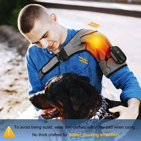 Man using Cordless Shoulder Heating Pad With Heat And Vibration while petting a dog outdoors, showing adjustable shoulder wrap.