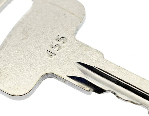 Close-up of metallic 455 ignition key for scissor and boom lifts, fits Genie, Skyjack, Terex Snorkel Upright platforms.