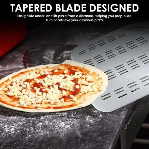 12 Inch Aluminum Perforated Pizza Peel with Lightweight Slotted Design next to pizza on countertop.
