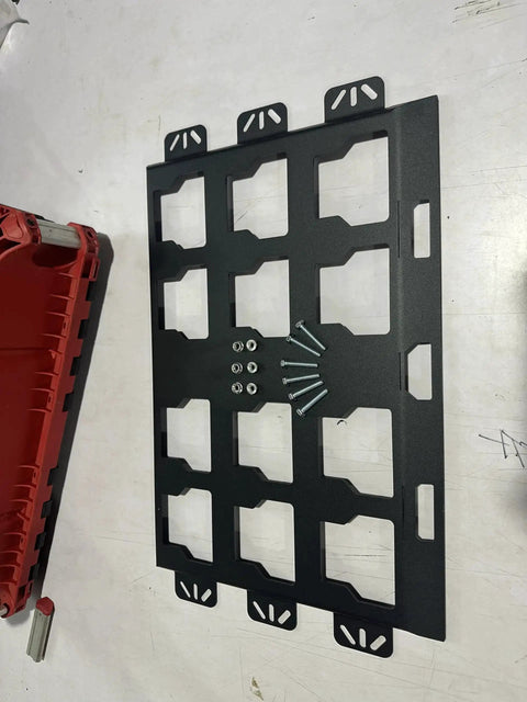 Milwaukee Packout Wall Mounting Plate Dope Metal Base, screws visible, on white surface, compatible with MOLLE panels