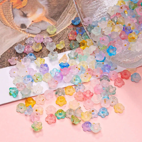 Acrylic Frosted Flower Beads Six Millimeter With Golden Speckles in storage box for jewelry making projects.