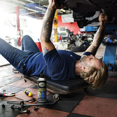Mechanic using Industrial Strength Penetrating Lubricant Spray For Bolts Screws Nuts And Locks 12 Oz Case Of 12 on vehicle
