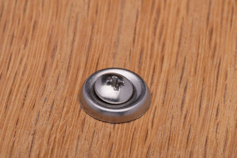 Stainless steel No. 10 cup washer with countersunk finish on wood surface