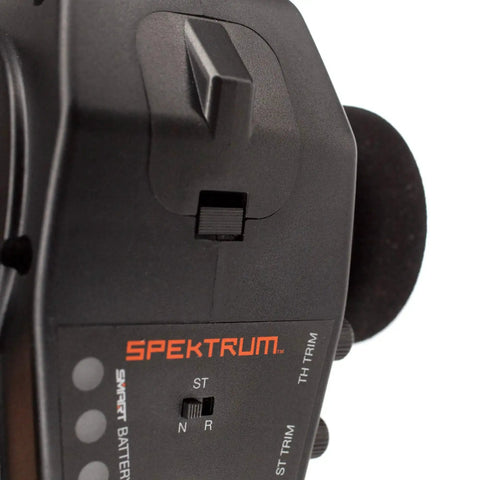 DX3 Smart Three Channel Transmitter with SR315 Receiver close-up showing steering trim controls, foam-covered wheel, and branding.