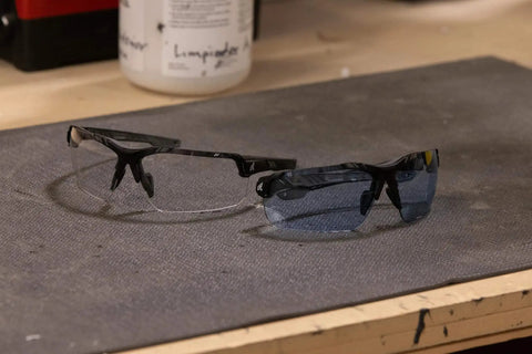 Tacana ANSI Z87.1 Safety Glasses with Anti Fog Lenses shown on a workbench, featuring polycarbonate lenses and black frames.