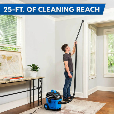 Man using 4 Gallon Wet Dry Vacuum With 5 Peak HP Two Stage Industrial Motor for cleaning high wall areas in a room.