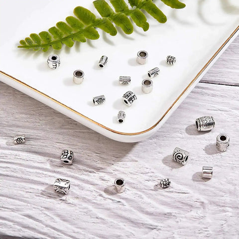 260 Pcs Tibetan Spacer Beads Set 7 Styles Antique Silver Column Tube Metal Spacers For Bracelet Necklace Jewelry Making Hole 1.5 To 3.5 mm Great For DIY Jewelry Projects And Bead Crafts displayed on a tray and wooden surface