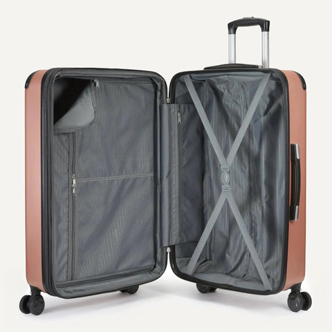 Open view of 22-inch expandable hardside suitcase in rose gold, part of Versatile Three Piece Travel Set With 22 Inch Expandable Hardside Suitcase Eight Spinner Wheels 15 Inch Tote Bag And 10 Inch Compact Carry On Rose Gold Finish Durable Luggage Set For Weekend Getaways And Business Trips By Amazon Basics showing interior compartments and spinner wheels.