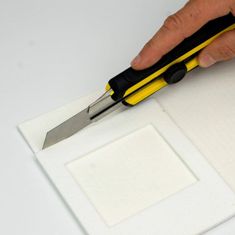 Lynn Manufacturing high-temp gasket paper being cut with a utility knife; white 1/8" thick, 15" x 24" sheet, ceramic fiber alternative.