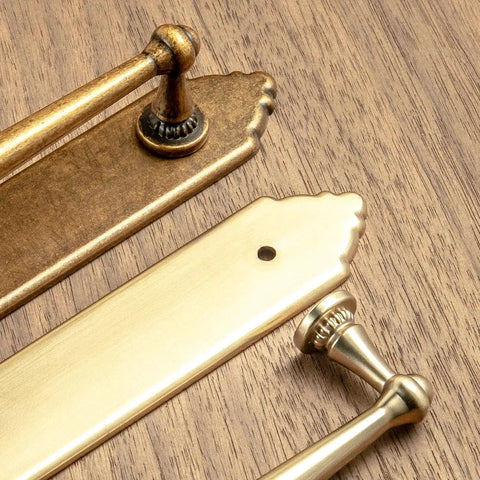 Close-up of Champagne Bronze Cabinet Pulls 5.04 Inch Center To Center With Back Plate Zinc Alloy 2 Pack on wooden surface