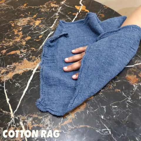 Hand using Blue Cotton Shop Towels Pack Of 150 12x14 Inches Absorbent Cleaning Rags on marble surface