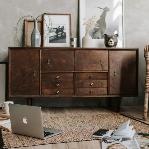 Wooden sideboard with Antique Brass Drop Pull Handles 4 Pack Featuring Ornate Pendant Drawer Knobs and décor items.