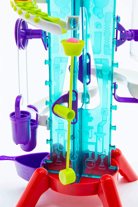 Thames and Kosmos Gumball Machine Maker front view; blue panels, red base, purple gears, yellow lever, pink gumball.