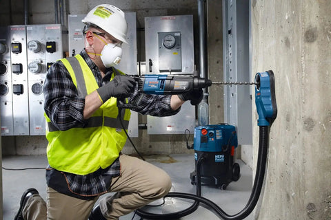 Worker using Two Cutter Head SDS-Plus Rotary Hammer Bit For Concrete Drilling, One Half Inch By Six Inch By Eight Inch, Bulldog Style.
