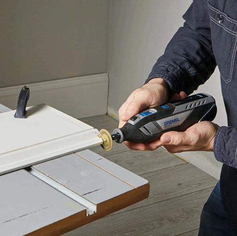 Person using Powerful 12V Cordless Rotary Tool With Brushless Motor From Dremel for precise sanding on a wooden surface.