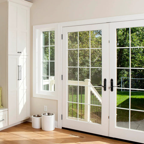 White French interior doors with grid glass panes and black lever handles.