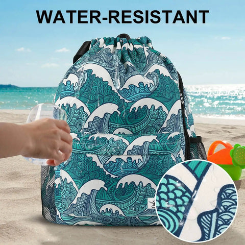 Drawstring Gym And Beach Backpack With Mesh Pockets, Water Resistant And Sandproof, shown on a sandy beach, Blue Waves design.