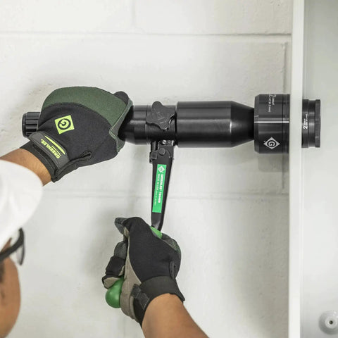 Using 8 Ton Hydraulic Knockout Punch Kit With Quick Draw Driver For Half Inch To Two Inch Holes to punch a hole in steel panel