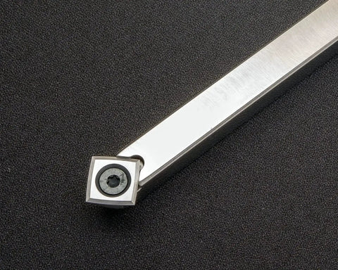 Mid Size 90 Degree Carbide Turning Tool For Acrylic Resin And Hybrid Woodturning On Lathe Pro Grade Stainless Steel Tool With 11mm Carbide Cutter And Negative Rake 9 Inch Shaft And 12 Inch Bright White Handle USA Made close-up view of carbide cutter end on black background