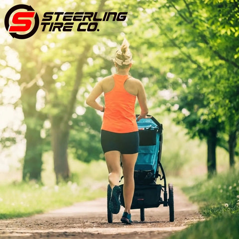 Jogger using a stroller with "Three Pack Jogging Stroller Tire Replacement Set With Two 16x1.75 Rear Tires And One 12.5x2.25 Front Tire BPA Latex Free Butyl Rubber For Real High Performance Safe Ride And Wide Compatibility With Three Wheel Strollers" on a park trail.