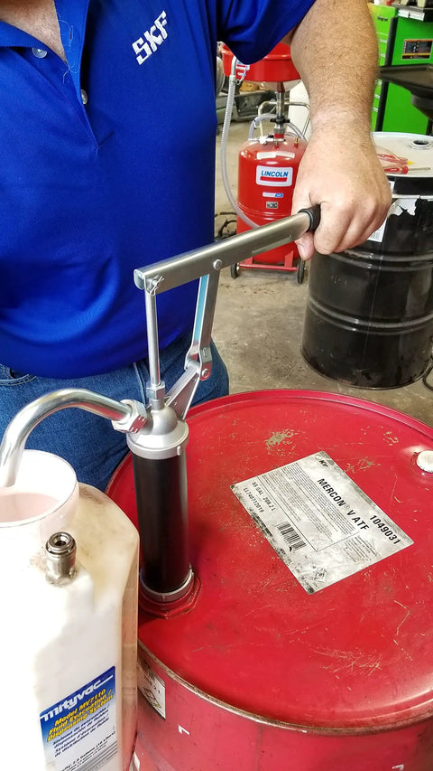 Person using Guardian Lever Action Drum Transfer Pump For 16 To 55 Gallon Drums With 2 Inch Bung And Bushing, oil transfer