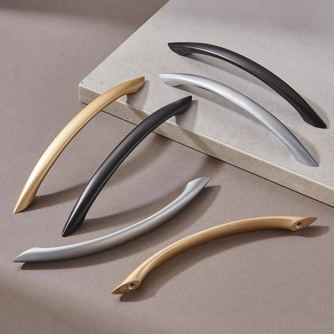 Variety of modern cabinet handles including Matte Black Arch Drawer Pulls, showcasing different finishes and designs.