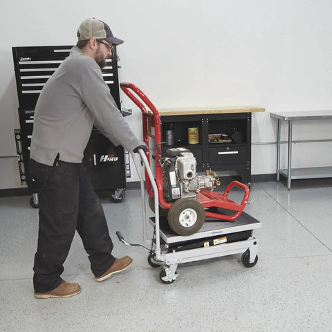 Strongway hydraulic lift table cart on red steel frame with casters carrying a small engine