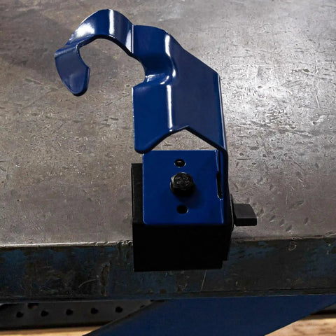Magnetic Base MIG Welding Torch Holder Pro Grade for secure positioning, attached to a metal surface in a workshop.