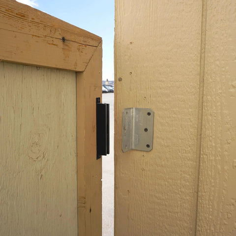 AM3 RM100C Magnet Catch Industrial Type with Mounting Holes Powder Coated Black Finish installed on gate