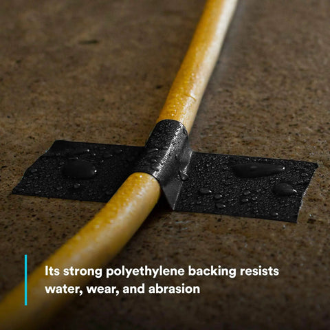 Extra Heavy Duty Industrial Duct Tape 6969, Gray, secures wet yellow cable on floor, abrasion resistant.