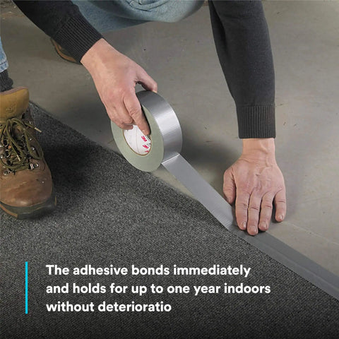 Applying Heavy Duty Duct Tape, Silver, 1 Pack, 1.88 in x 60 yd x 9.0 mil for sealing carpet edges on floor surface