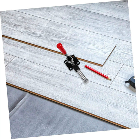 Fast Locking Level Fastener Push Pull Clamp For Vertical Fixtures on laminate flooring with red plastic handle.