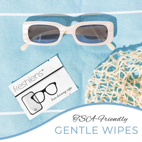 Lint-Free Lens Wipes, 50 Pre-Moistened Towelettes for glasses beside sunglasses on a blue background