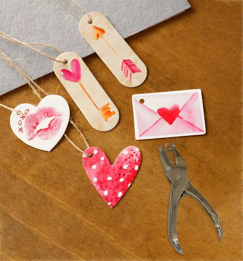 Circle Hole Punch Kit With One Quarter And One Eighth Inch Sizes Handy Handheld Puncher with craft tags on wooden surface