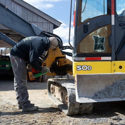 LockNLube heavy-duty pistol grip grease gun with a 20-inch hose used to grease an excavator.