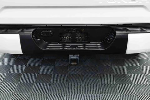 Rear vehicle bumper treated with Trim And Exterior Plastic Restorer With UV Protection Up To 2 Years 50 Ml, close-up view.