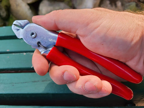 Person holding Heavy Duty Hog Ring Pliers With 3/8 Stainless Hog Rings Spring Loaded Jaws PVC Grips 7 Inch Auto Upholstery Tool