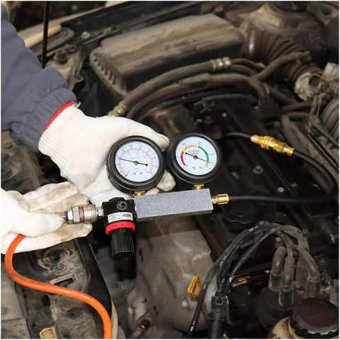 Multi-function cylinder leak-down tester kit with dual gauges, brass fittings, orange hose in engine bay.