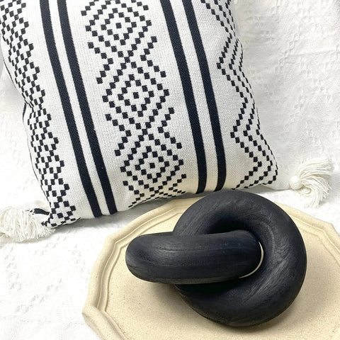 Two Link Wood Chain Decor Hand Carved Boho Farmhouse Style, black pine wood ring on decorative tray, patterned pillow background.