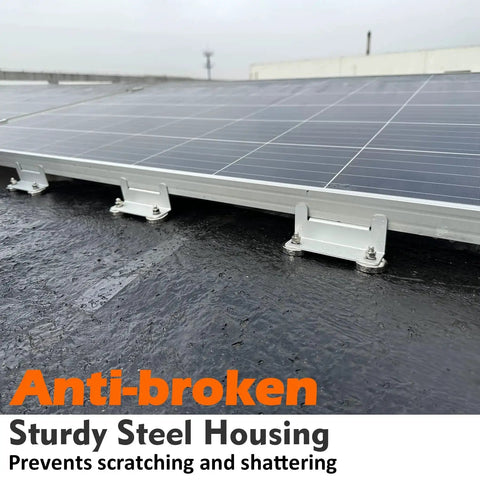 Solar panel mounted on a rooftop using metal clamps and screws.