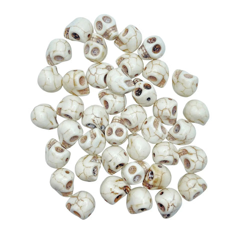 40 Pack 12mm White Skull Beads For Jewelry Making Howlite Skeleton Beads scattered on a surface, ideal for goth craft supplies.