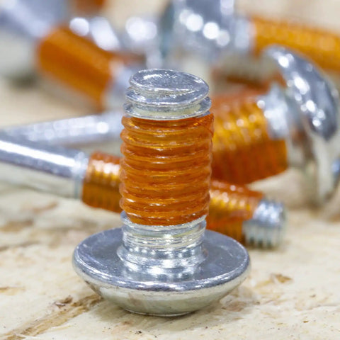 Close-up of VC-3 Threadmate Red Threadlocker And Tape Kit on threaded fastener, showing red coating on metal threads.