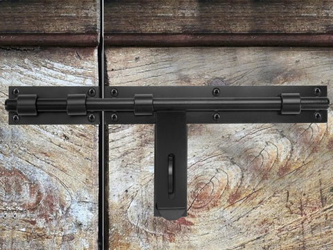 Heavy Duty 17-Inch Carbon Steel Slide Bolt Latch installed on a wooden barn door, designed for security with left or right hand mount.