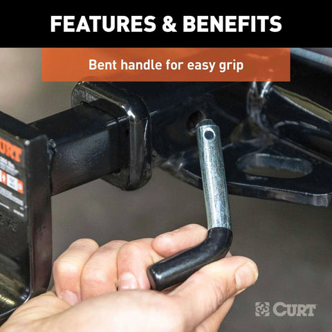 Trailer Hitch Pin and Clip With Vinyl Coated Grip, Half Inch Diameter, Fits One And One Quarter Inch Receiver, shown being installed