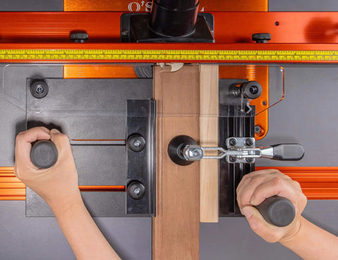 Pro Grade Rail Coping Sled Router Table Jig for Cabinet Doors in use showing secure clamping on phenolic base for precise joinery.