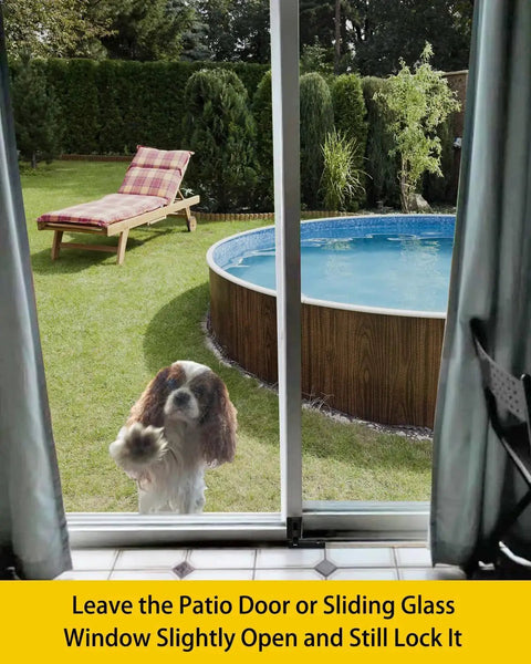 Dog looking through glass sliding door fitted with Glass Sliding Door Lock Black Foot Lock For Patio And Sliding Doors Extra Security For Home And Travel Child Safety Lock For Sliding Doors Sliding Door Stopper And Secure Access Device To Prevent Unwanted Openings Peace Of Mind in backyard.
