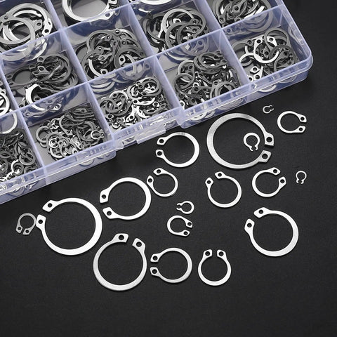 300 Piece Retaining Ring Set With Internal And External Snap Rings In Stainless Steel Circlip Retention Rings 18 Size Assortment For Grooved Shafts Pins And Studs Durable Rust Resistant And Easy To Use displayed in a box and scattered outside