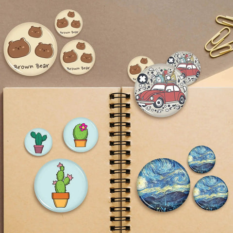 Front view of several 32mm metal button badge blanks and finished badges with bear, cactus, and car designs.
