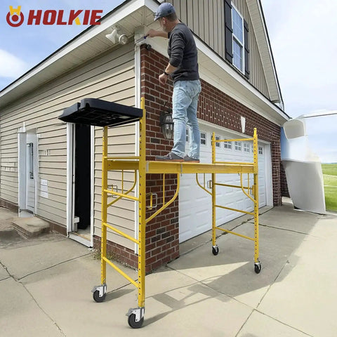 Man standing on scaffold with 5 Inch Scaffolding Caster Wheels Set Of Four With Dual Locking Swivel Casters And One And A Quarter Inch Square Stem For Stainless Steel Scaffold Tubes Heavy Duty Replacement Castors 1190 Lb Load Capacity Industrial Grade