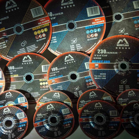 Multiple cutting wheels arranged, showing different sizes and labels, illustrating metal cutting wheel variety in a workshop setting.